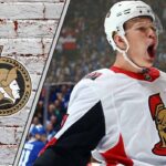 Brady Tkachuk passionately celebrating a goal for the Ottawa Senators, embodying leadership and determination.