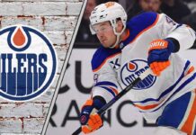 Edmonton Oilers defenseman Ty Emberson skates with the puck during an NHL game, representing a potential trade asset for the team amid roster decisions.