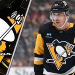 Evgeni Malkin, Pittsburgh Penguins center, skates with the puck during a power play, anticipating a pass to Sidney Crosby or Erik Karlsson.