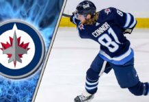 Winnipeg Jets forward Kyle Connor skates with puck in contract negotiation discussion