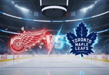 A widescreen promotional image for a hockey game between the Detroit Red Wings and the Toronto Maple Leafs. At center ice of the Maple Leafs' home arena, the stylized, glowing red logo of the Red Wings collides with the glowing blue logo of the Leafs, with the word 'VS' between them.