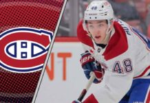 Montreal Canadiens defenseman Lane Hutson skating with the puck during an NHL game.