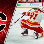 An action shot of Nazem Kadri skating in his Calgary Flames uniform during an NHL game.
