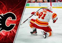 An action shot of Nazem Kadri skating in his Calgary Flames uniform during an NHL game.