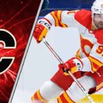 Calgary Flames center Nazem Kadri skates during an NHL game, looking focused despite recent NHL trade rumors surrounding him and the team.