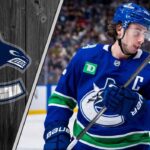 Vancouver Canucks captain Quinn Hughes on the ice, skating with his stick.