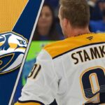 A focused Steven Stamkos skating in his Nashville Predators uniform during a game.