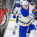 Tage Thompson to the New Jersey Devils: A Franchise-Altering Move in the Making? Buffalo Sabres forward Tage Thompson skates with the puck during an NHL game, with the New Jersey Devils logo in the background.