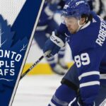 Nick Robertson: The Odd Man Out in Toronto? Toronto Maple Leafs forward Nick Robertson skates with the puck during an NHL game.