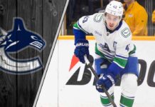 Vancouver Canucks captain Quinn Hughes skates with the puck during a game, contemplating his future with the team amidst NHL trade rumors.
