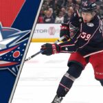Yegor Chinakhov’s Trade Request on Hold: What’s Really Going on in Columbus? Columbus Blue Jackets forward Yegor Chinakhov skates with the puck during an NHL game, with the Blue Jackets logo visible in the background.