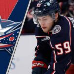 Columbus Blue Jackets forward Yegor Chinakhov skates during an NHL game, looking for a pass amidst NHL trade rumors.