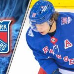 Artemi Panarin of the New York Rangers looking down ice during a game, subject of trade rumors to Carolina and Minnesota.
