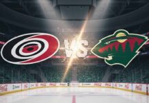 A widescreen image showing the Carolina Hurricanes logo on the left and the Minnesota Wild logo on the right, with "VS" stylized between them, all superimposed over a blurred background of an ice hockey arena with bright spotlights.