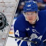 The Kampf-ather: Why 4 Teams Are Scrambling to Sign the Ex-Maple Leafs Center David Kampf in his Toronto Maple Leafs jersey, looking on intently as he skates, representing his free agency.