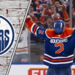 Edmonton Oilers defenseman Evan Bouchard celebrating scoring a goal, showcasing his powerful offensive skills and contribution.
