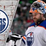 Edmonton Oilers goalie Stuart Skinner looks dejected during a game, highlighting the team's need for a goaltending upgrade.