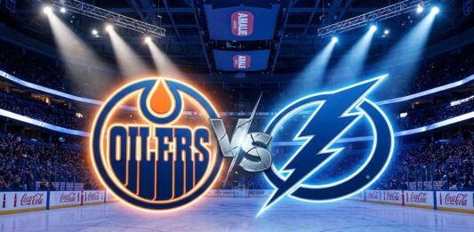 A wide-angle view inside a crowded hockey arena, featuring large, illuminated Edmonton Oilers and Tampa Bay Lightning logos colliding at center ice with a stylized metallic "VS" between them.