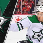 Jason Robertson of the Dallas Stars celebrating a goal, looking towards the scoreboard.