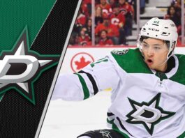 Jason Robertson of the Dallas Stars celebrating a goal, looking towards the scoreboard.