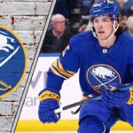 Buffalo Sabres defenseman Owen Power skating with the puck, analyzing trade rumors and defensive performance.