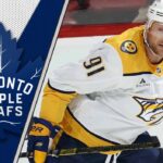 Steven Stamkos skates in a Nashville Predators jersey, looking towards the Toronto Maple Leafs logo in a conceptual trade image.