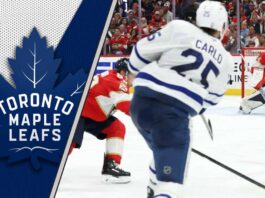 Brandon Carlo of the Toronto Maple Leafs skating with the puck during an NHL game at Scotiabank Arena.