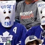 Dejected Toronto Maple Leafs fans in the stands symbolizing their failing 2025-26 season.