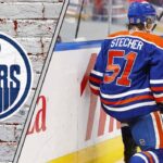 Edmonton Oilers defenseman Troy Stecher skating in his blue and orange jersey celebrating a goal.