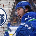 Vancouver Canucks forward Kiefer Sherwood skates during an NHL game, a potential trade target for the Edmonton Oilers.
