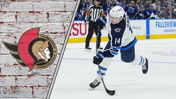 ville-heinola-winnipeg-jets-ottawa-senators-target Ottawa Senators target Ville Heinola skating in his Winnipeg Jets jersey during an NHL game, looking to make a play.