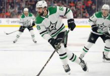 A photo of Dallas Stars player Alex Tuch, wearing number 89, skating with the puck during a game. Two other Stars players are in the background.