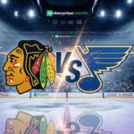 Rivalry Night: How to Watch Blackhawks vs. Blues on Friday, Dec. 12 Chicago Blackhawks and St. Louis Blues logos colliding on a hockey rink inside the Enterprise Center, with a large 'VS' between them and spotlights shining on the ice.