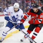 How to Watch New Jersey Devils at Toronto Maple Leafs: TV & Streaming Guide Toronto Maple Leafs' John Tavares (91) and New Jersey Devils' Jack Hughes (86) battle fiercely for possession of the puck along the boards during an NHL game.