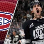 Los Angeles Kings center Phillip Danault skating during a game, subject of recent NHL trade rumors regarding a potential move to Montreal or New Jersey.