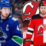 A split image graphic illustrating NHL trade rumors involving Quinn Hughes. On the left side, Hughes is pictured on the ice wearing his current blue Vancouver Canucks jersey. The right side is a composite graphic showing Hughes wearing a jersey split down the middle—the left half is the red and black of the New Jersey Devils, and the right half is the red and white of the Detroit Red Wings