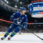 Panic in Vancouver? Why a Quinn Hughes Trade Might Be Inevitable Vancouver Canucks captain Quinn Hughes skating with the puck, subject of 2026 NHL trade deadline rumors and interest from the New Jersey Devils.