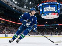 Panic in Vancouver? Why a Quinn Hughes Trade Might Be Inevitable Vancouver Canucks captain Quinn Hughes skating with the puck, subject of 2026 NHL trade deadline rumors and interest from the New Jersey Devils.