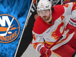 Calgary Flames defenseman Rasmus Andersson skating with the puck, linked to New York Islanders trade rumors.