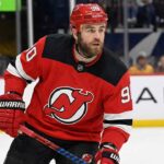 Ryan O’Reilly to the New Jersey Devils: The Real Hurdle Behind the Rumors Image showing NHL center Ryan O'Reilly wearing a red New Jersey Devils home jersey, number 90, helmet, and gloves while on the ice.