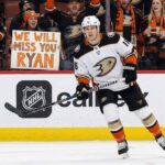Report: Anaheim Ducks Open to Trading Ryan Strome Amid Roster Crunch Anaheim Ducks player number 16, Ryan Strome, skates on the ice, looking towards fans behind the glass. A fan in the front row holds up a handwritten sign that says "WE WILL MISS YOU RYAN".
