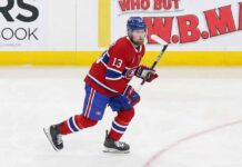 Alexis Lafrenière skating on the ice wearing a red Montreal Canadiens home uniform with the number 13 and a blue helmet.