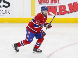 Is Alexis Lafrenière a Fit for Montreal? The Hard Truth Behind the Rumors Alexis Lafrenière skating on the ice wearing a red Montreal Canadiens home uniform with the number 13 and a blue helmet.