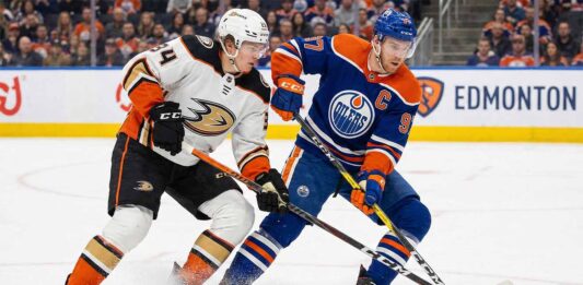 Ducks vs. Oilers Tonight: TV Channel, Time, & Can Anaheim’s Streak Continue? Anaheim Ducks forward Cutter Gauthier (left), wearing a white number 34 away jersey, battles for control of the puck against Edmonton Oilers captain Connor McDavid (right), wearing a blue number 97 home jersey, during an NHL game on the ice at Rogers Place in Edmonton.