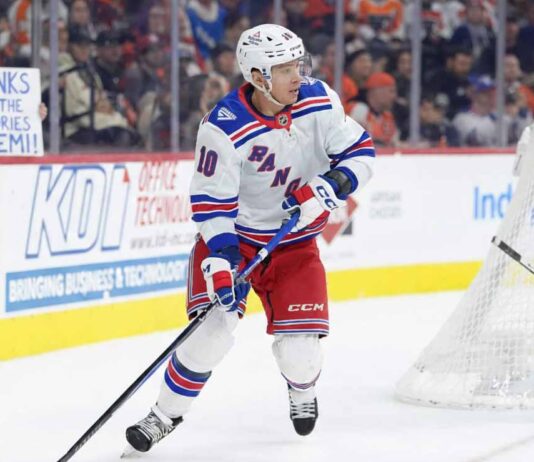 Artemi Panarin of the New York Rangers skating in his home jersey while a female fan in the stands wearing a Rangers jersey holds a sign reading "Thanks for the memories Artemi!" amidst trade rumors.