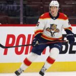 Florida Panthers defenseman Connor Murphy, wearing number 5 in a white away jersey, skates with the puck during a game.