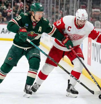 How to Watch Detroit Red Wings at Minnesota Wild: TV, Time & Odds (Jan 22, 2026) Minnesota Wild's Kirill Kaprizov (#97 in green jersey) and Detroit Red Wings' Dylan Larkin (#71 in white jersey) battle for possession of the puck against the rink boards during an NHL game.