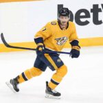 Nashville Predators defenseman Dougie Hamilton skating in his yellow #7 Nashville Predators home jersey.