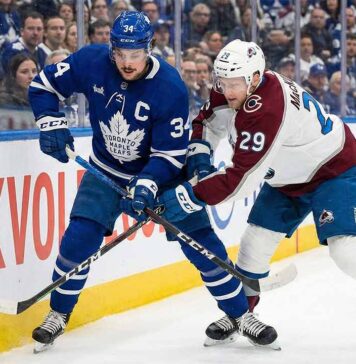 Why Sunday’s Avs vs. Leafs Game Could Be the High-Scoring Thriller of the Year Toronto Maple Leafs captain Auston Matthews (34) and Colorado Avalanche forward Nathan MacKinnon (29) battle fiercely for the puck against the sideboards during an NHL game at Scotiabank Arena.