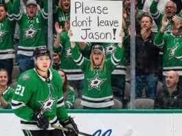 Why The Pittsburgh Penguins Are All-In On Jason Robertson Dallas Stars forward Jason Robertson skates on the ice while a female fan behind the glass holds a handwritten sign that reads, 'Please don't leave Jason!'.